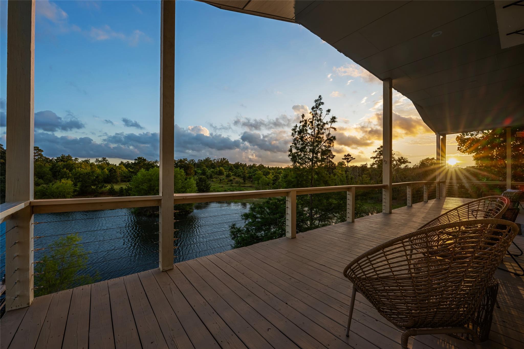 An inviting deck overlooks a serene waterfront, o