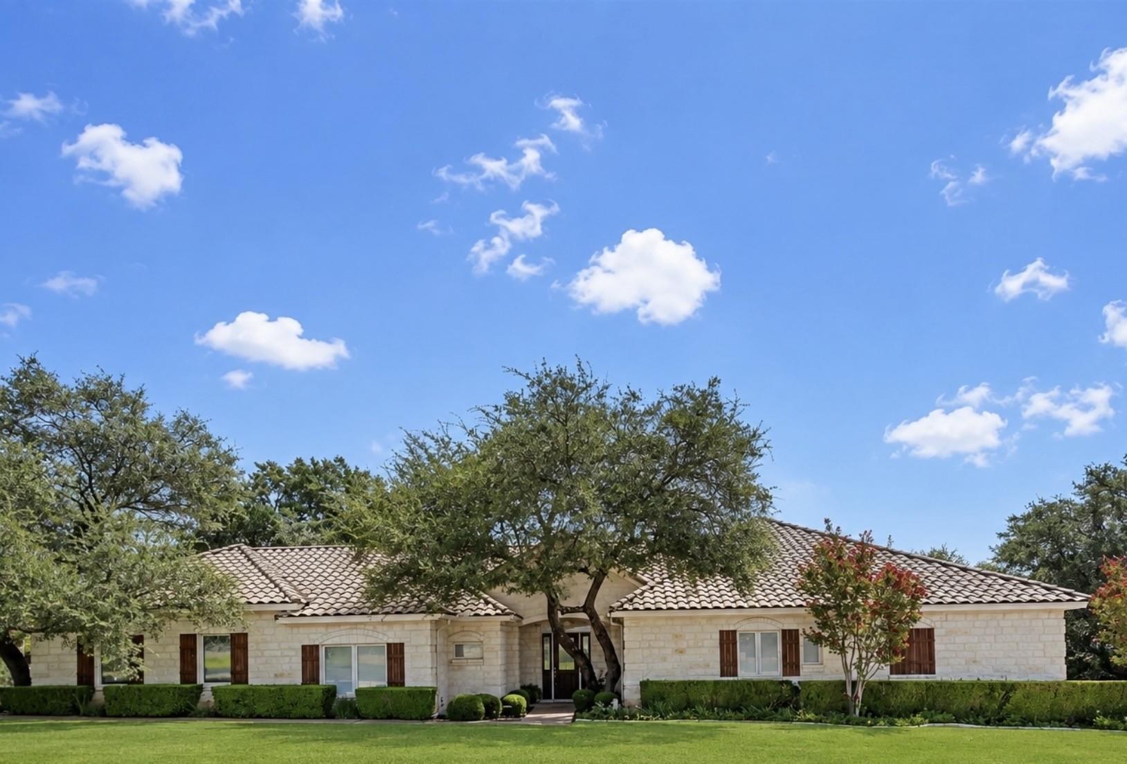 A graceful stone residence with a tiled roof, set