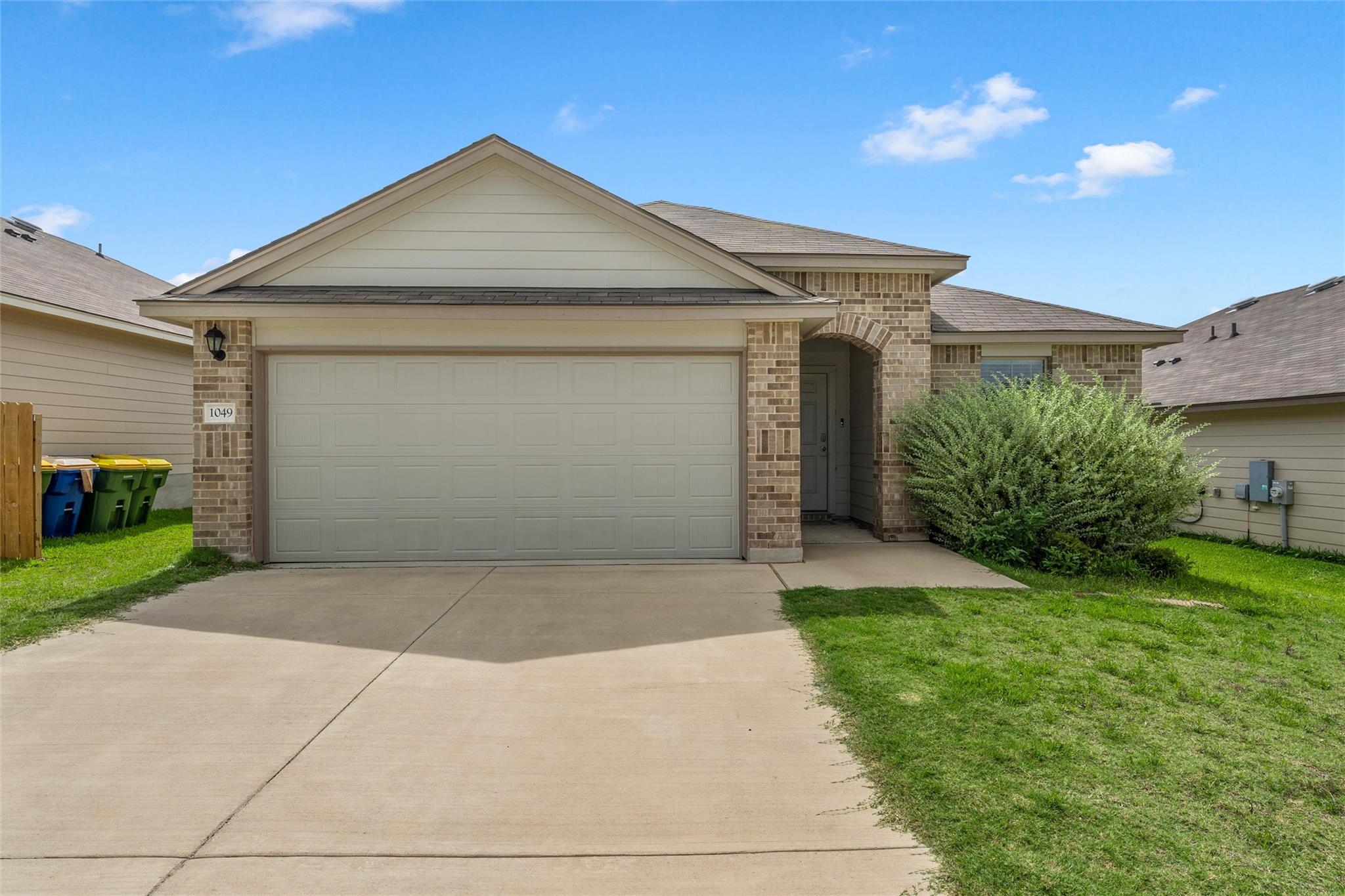 A welcoming brick facade with an attached garage 