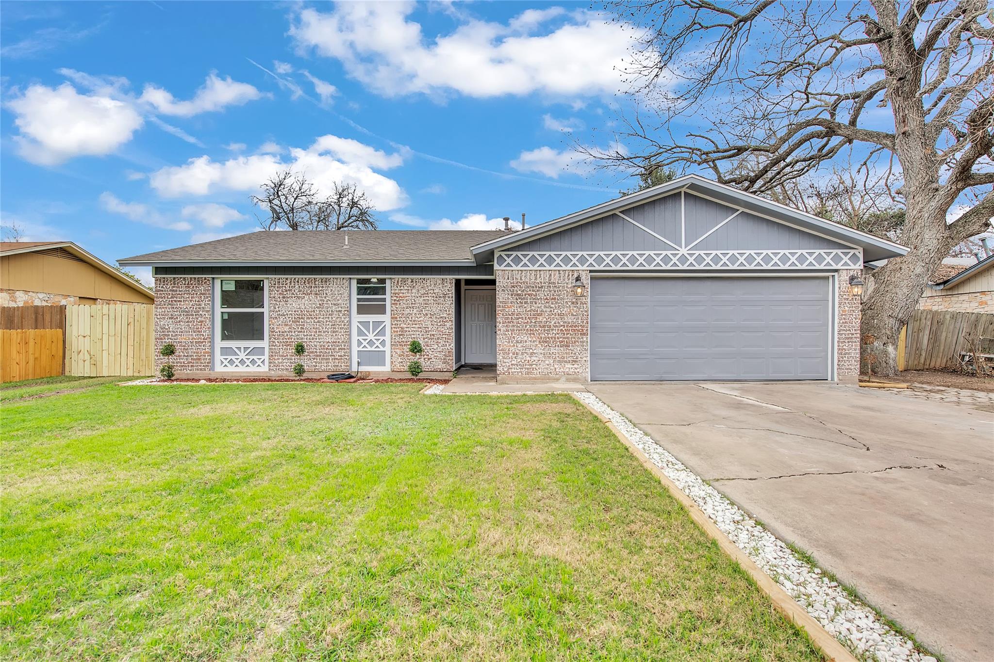 A well-kept front yard complements this single-st