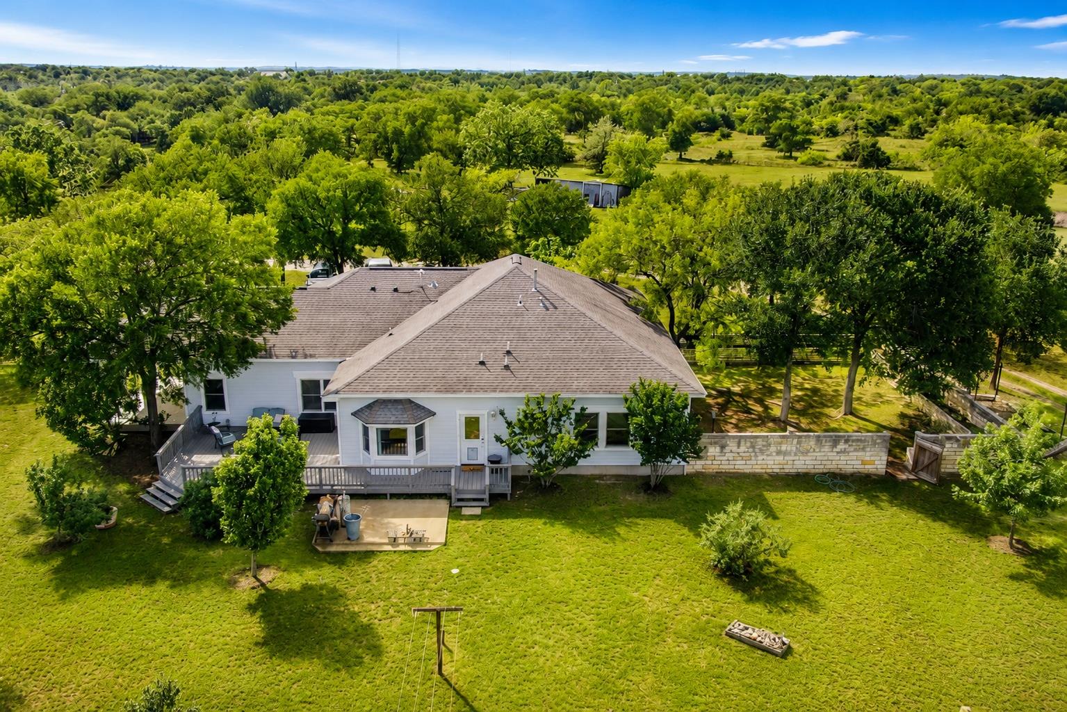 A spacious yard with mature trees and a multi-lev