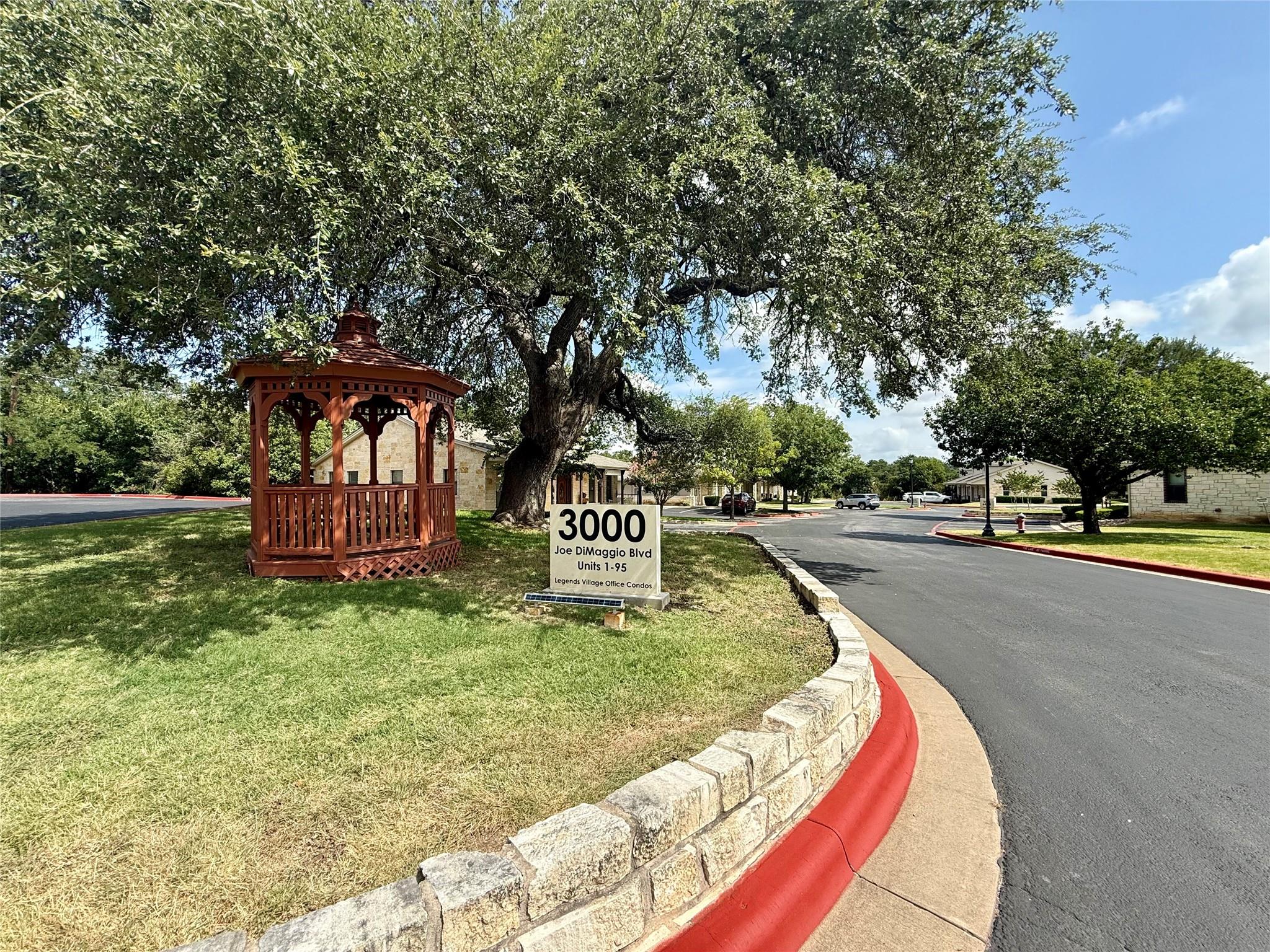 A charming gazebo and mature trees define the inv