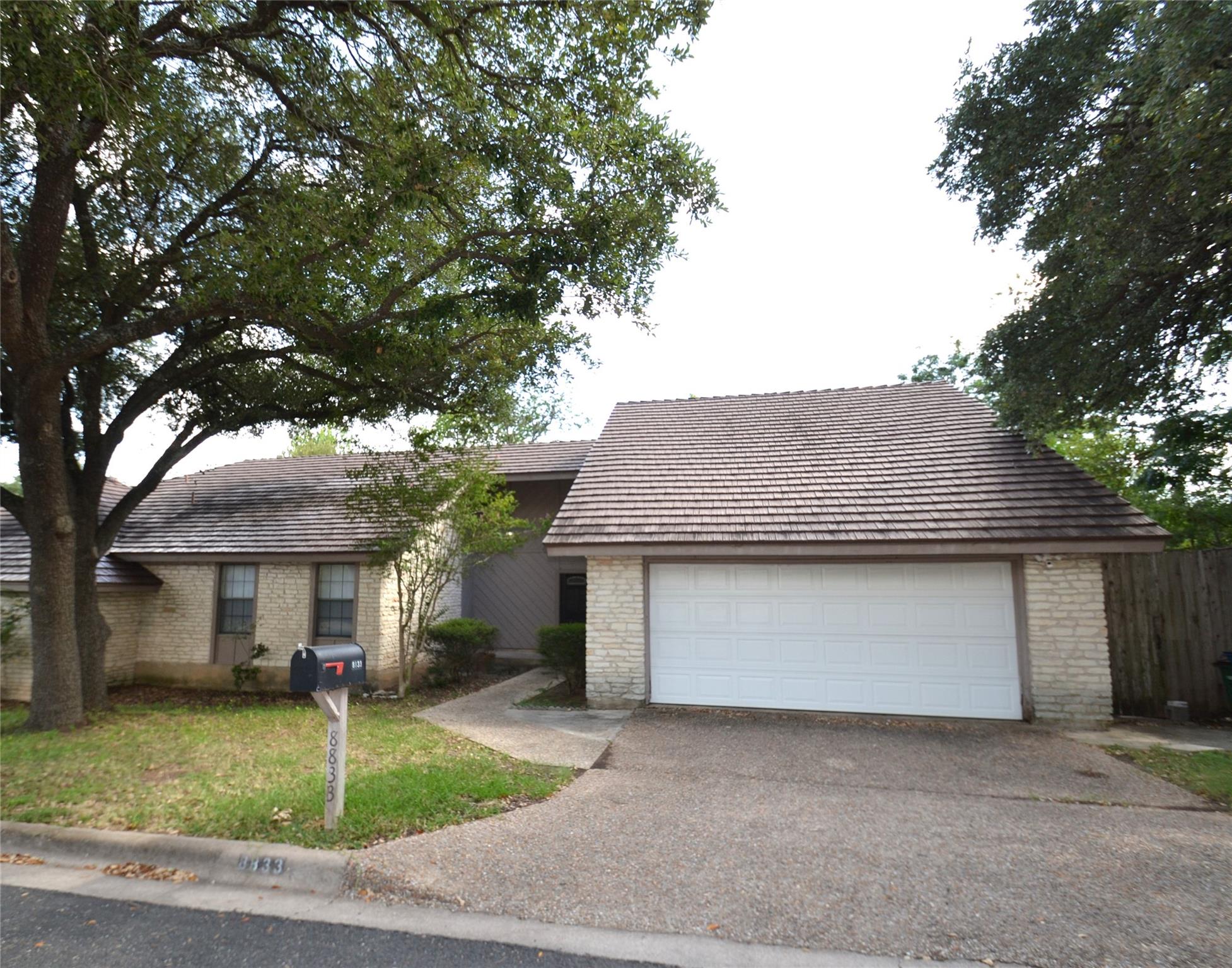 A well-maintained facade with an attached garage 