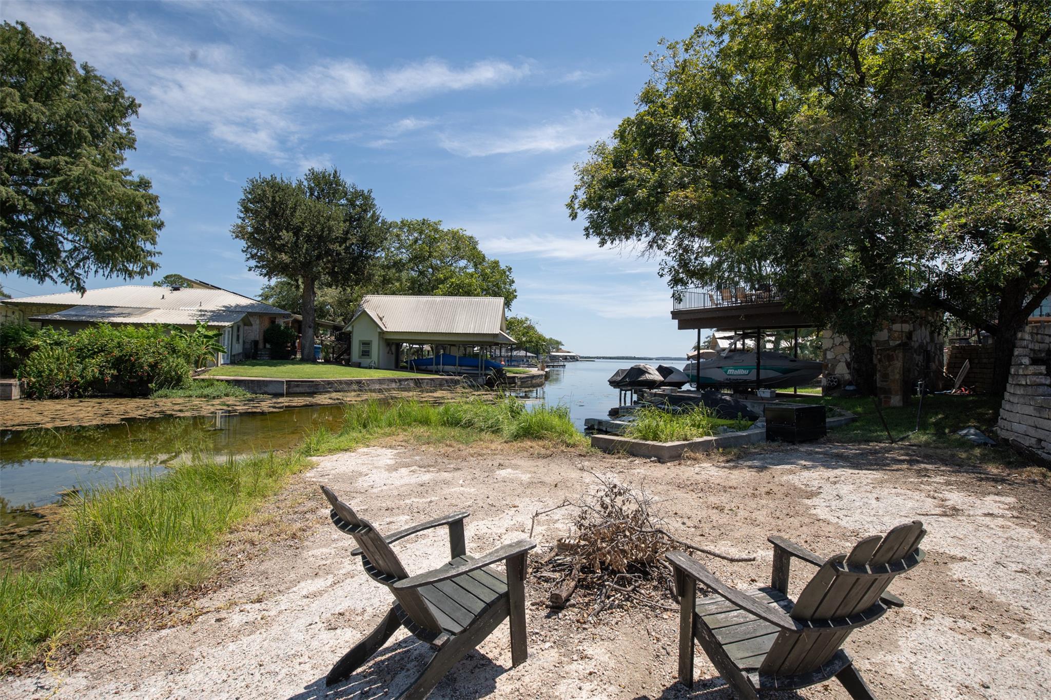 A spacious yard leads to tranquil waterfront with