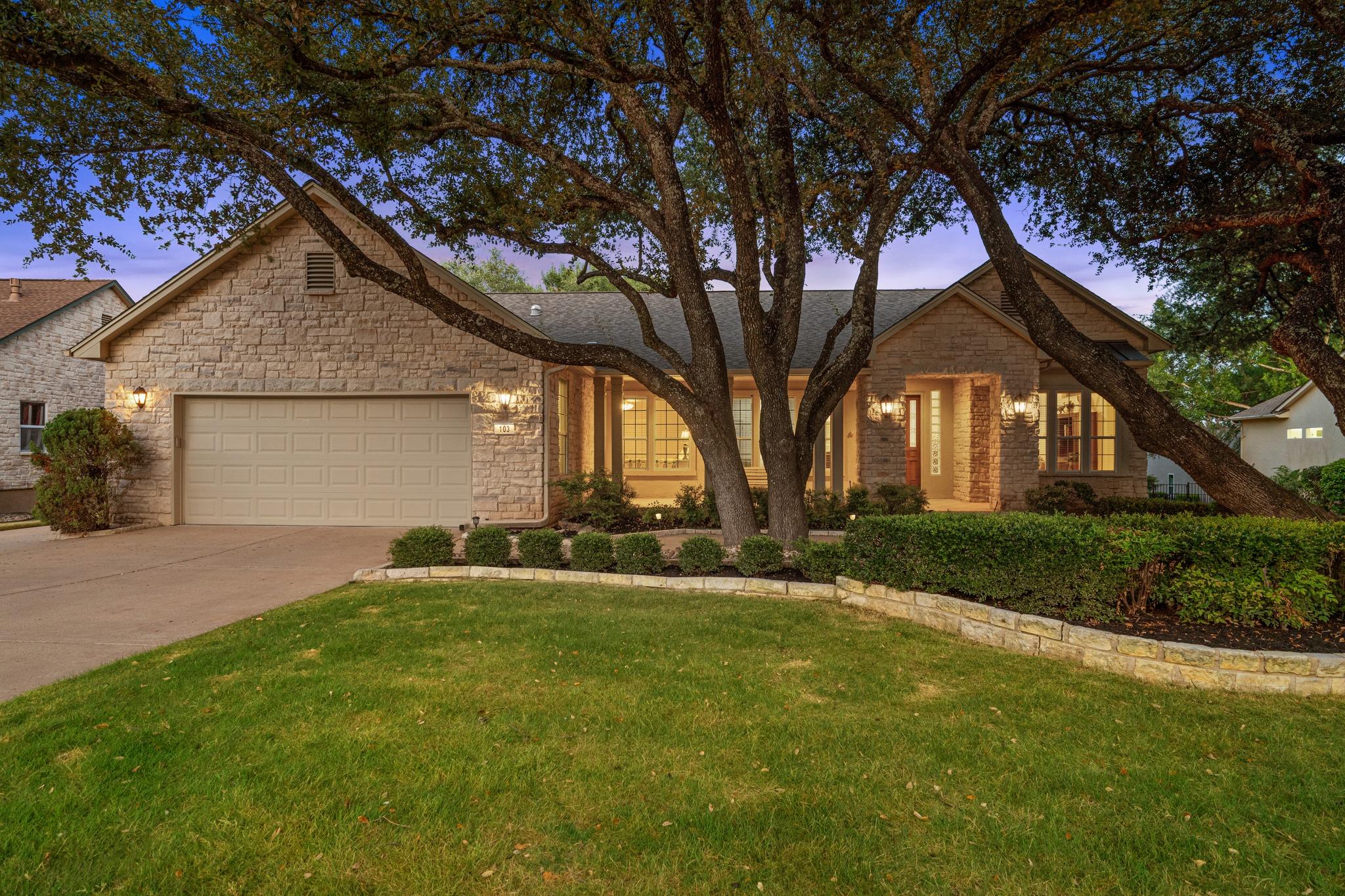 A welcoming stone facade home, beautifully illumi