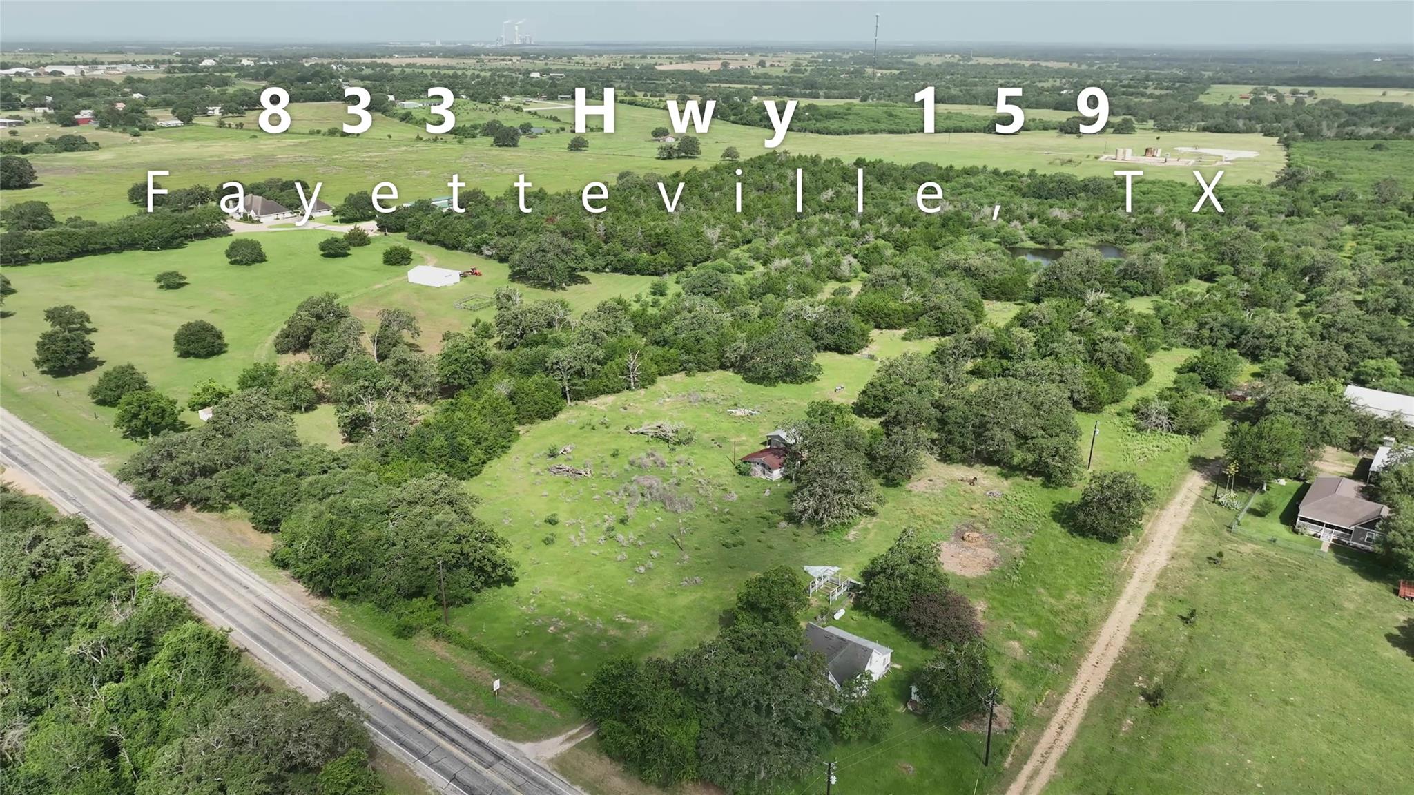 An aerial panorama reveals verdant acreage, matur