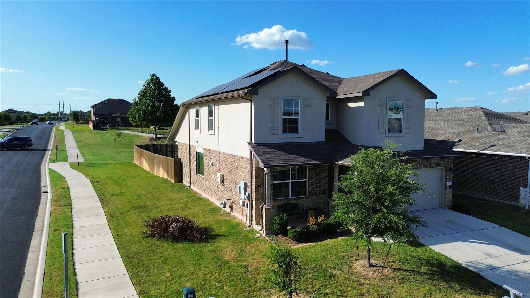 A classic two-story home with a brick and stucco 