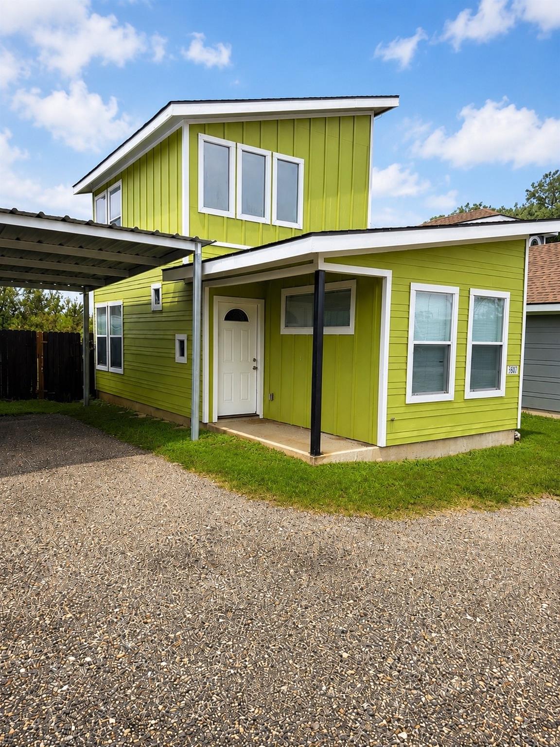 A vibrant green facade with clean white trim, off