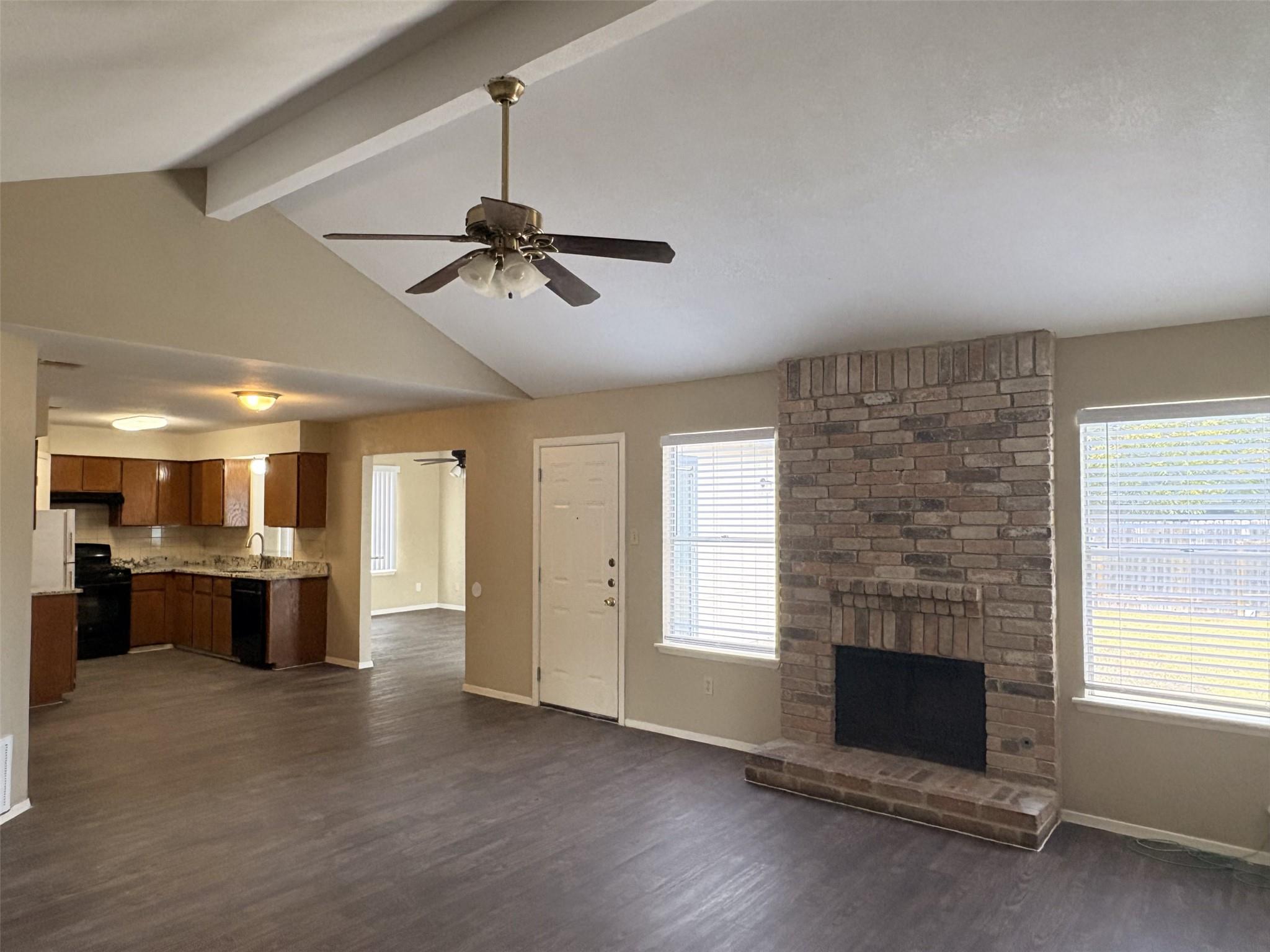 A classic brick fireplace anchors the living spac