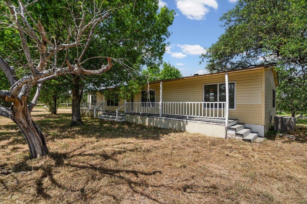 A quaint residential dwelling is surrounded by ma