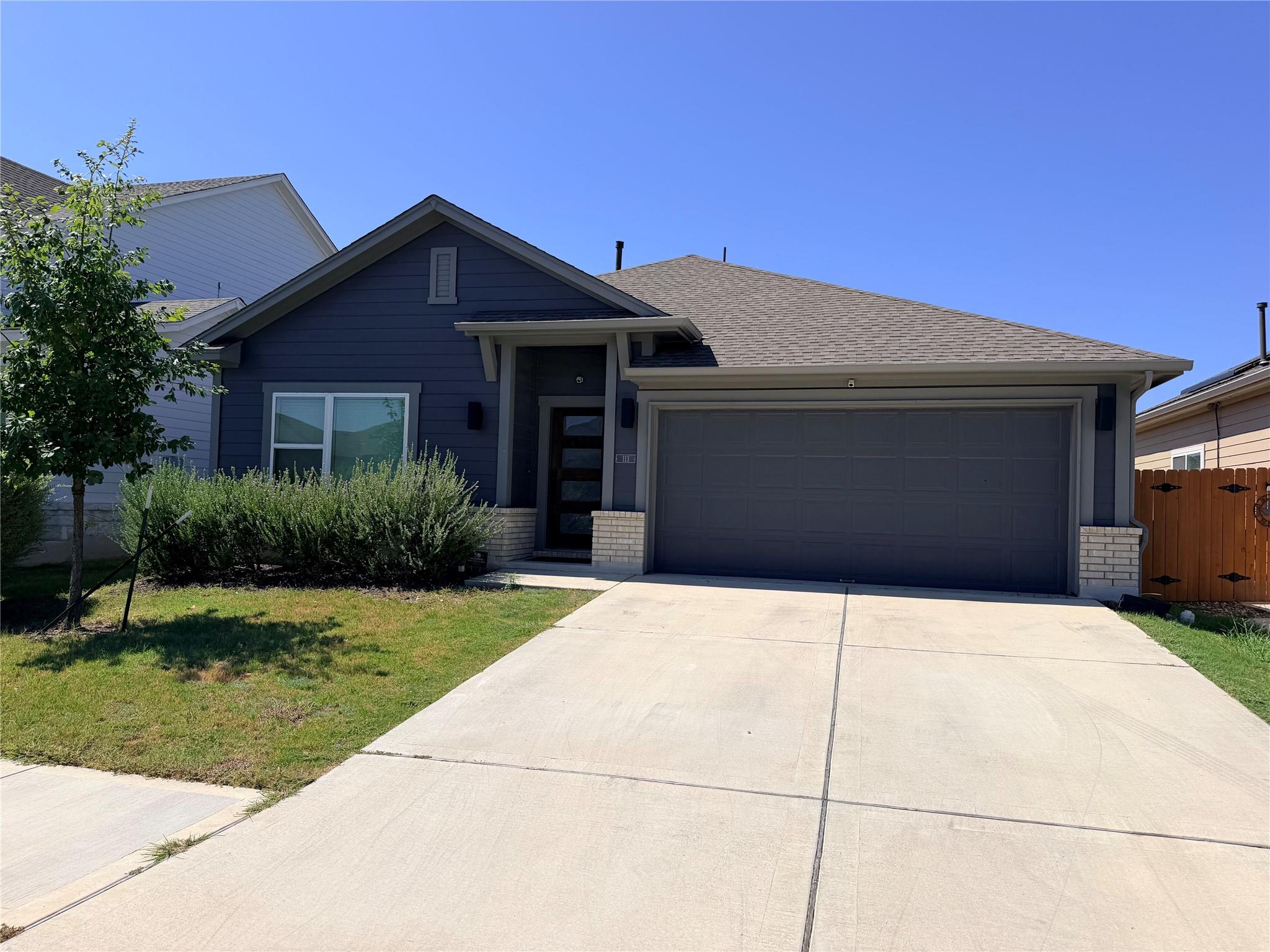 A welcoming facade showcases a wide driveway lead