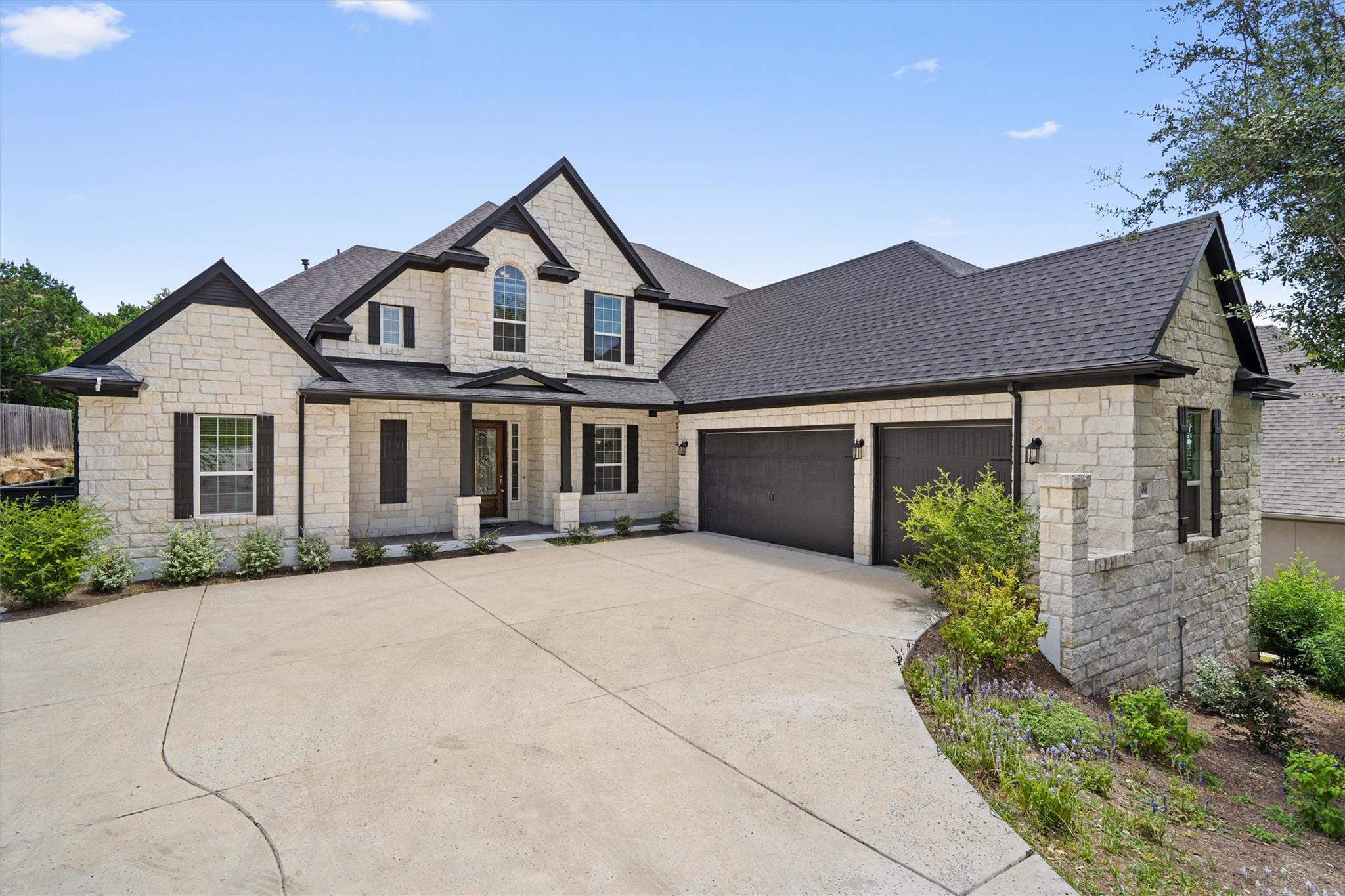 A stone-clad residence with a spacious driveway a