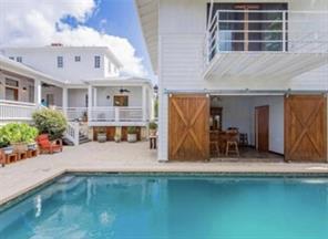 An inviting backyard oasis offers a sparkling poo