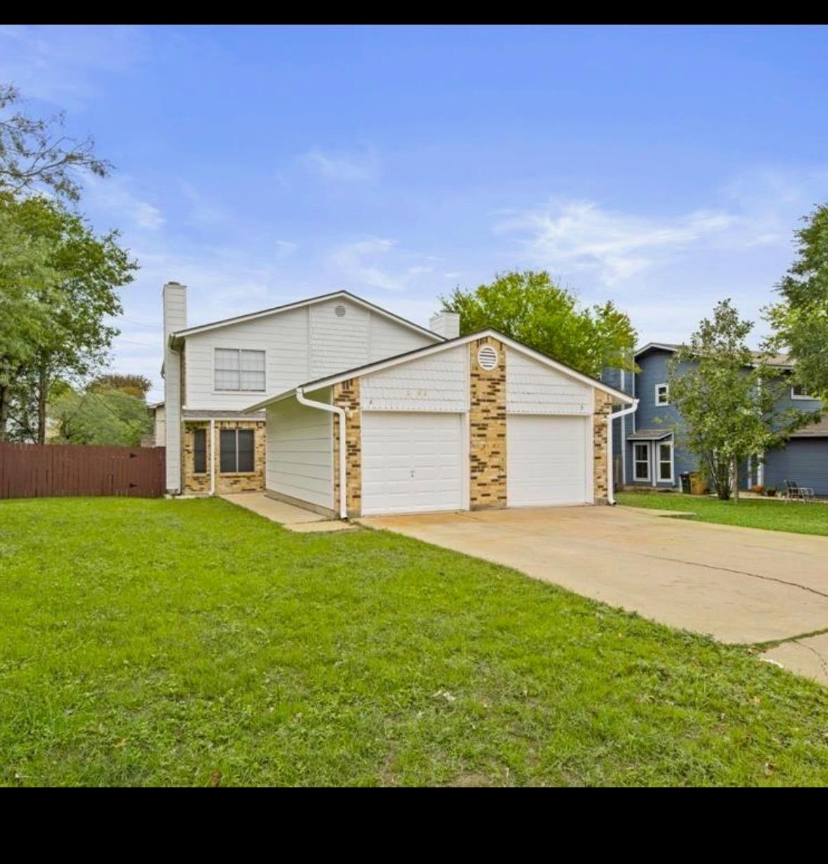 A classic two-story home features a two-car garag