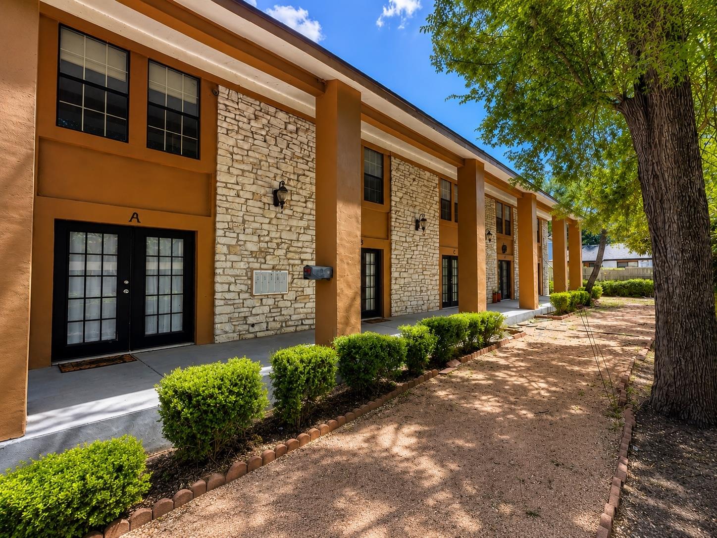 Striking stone accents and prominent pillars defi