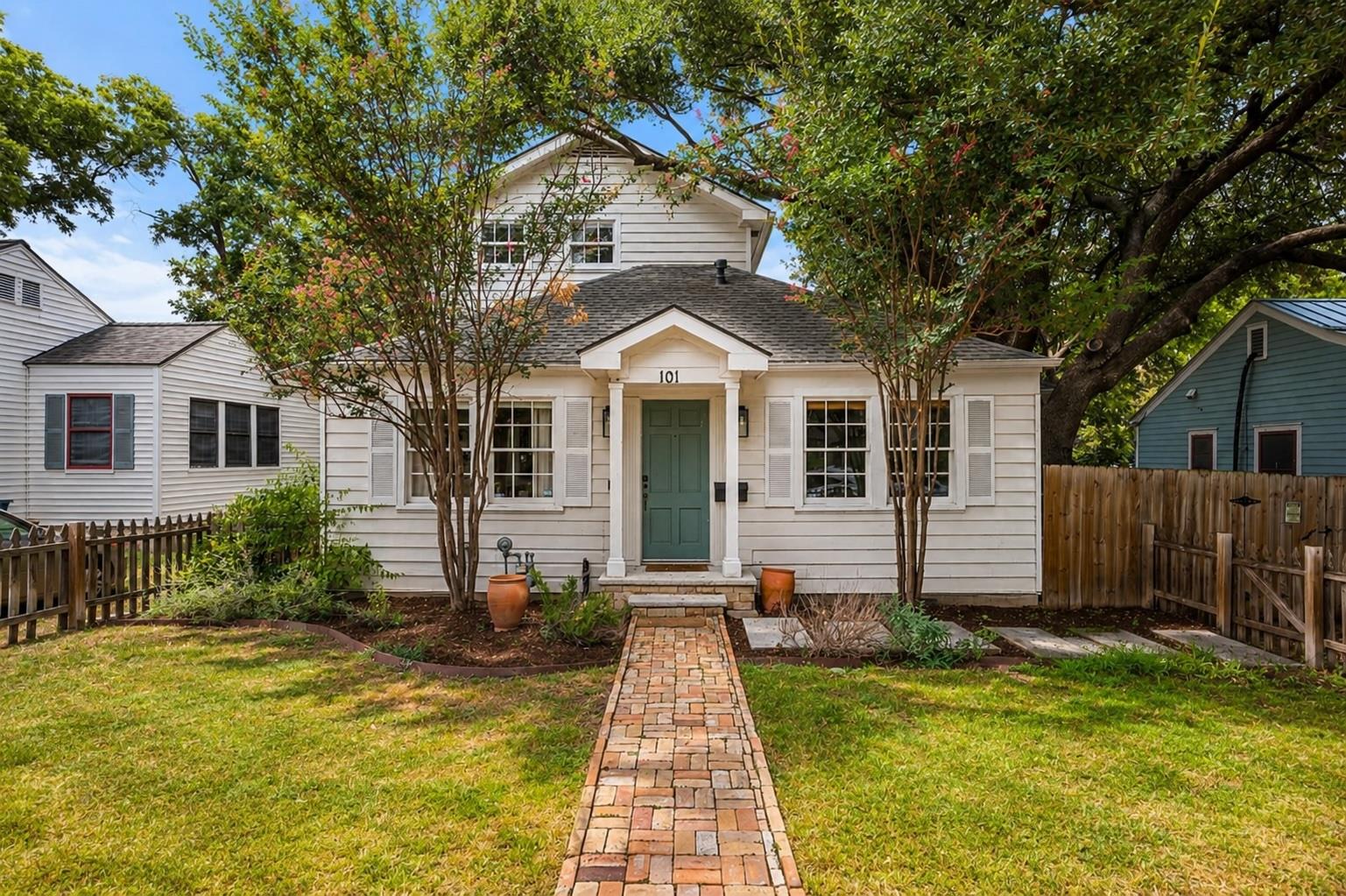 A charming white home with a welcoming blue door 