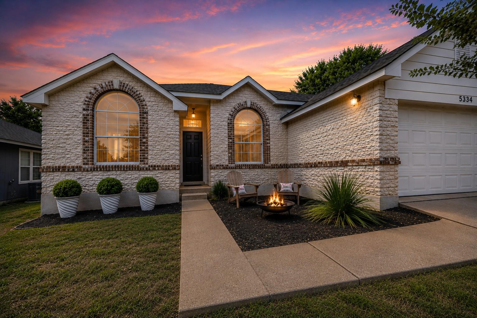 Textured stone veneer and arched window details e