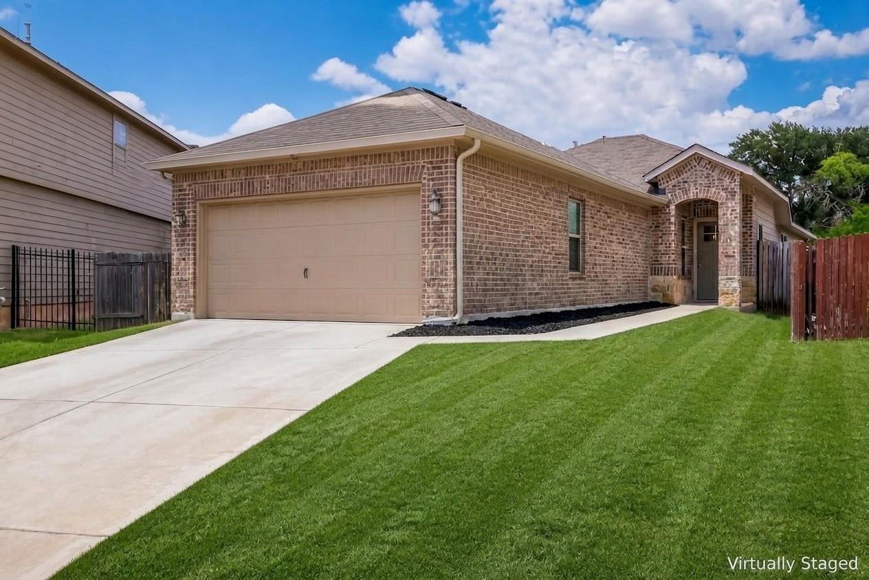 A well-maintained brick facade and verdant lawn c