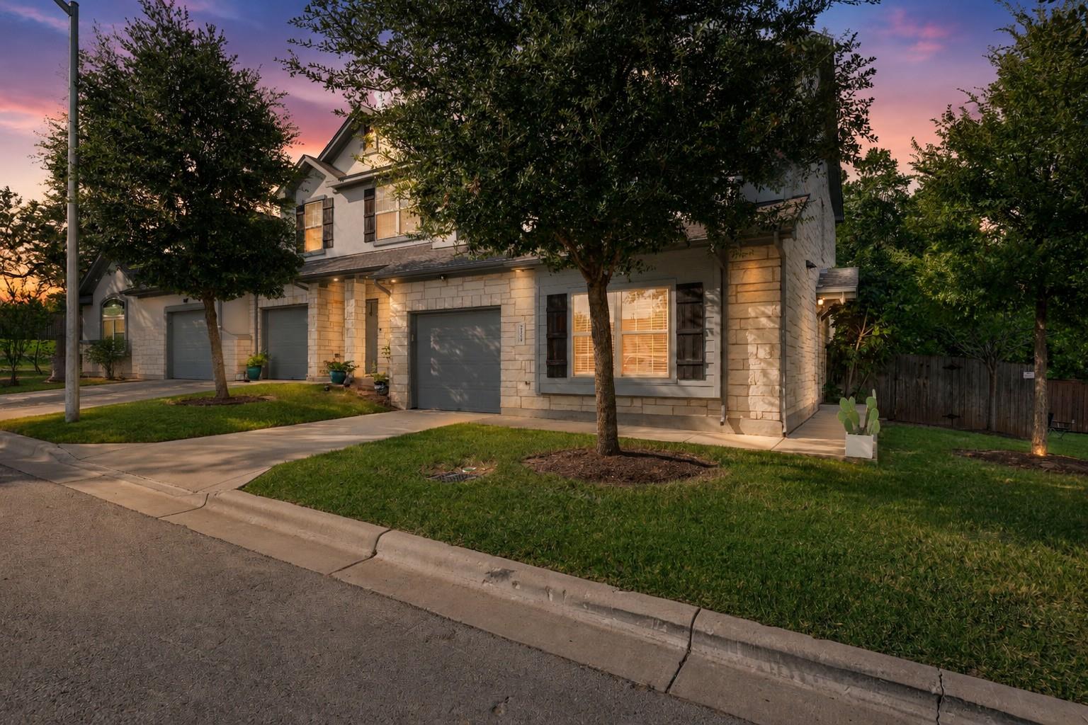 Stone-clad facade and well-tended lawns welcome y