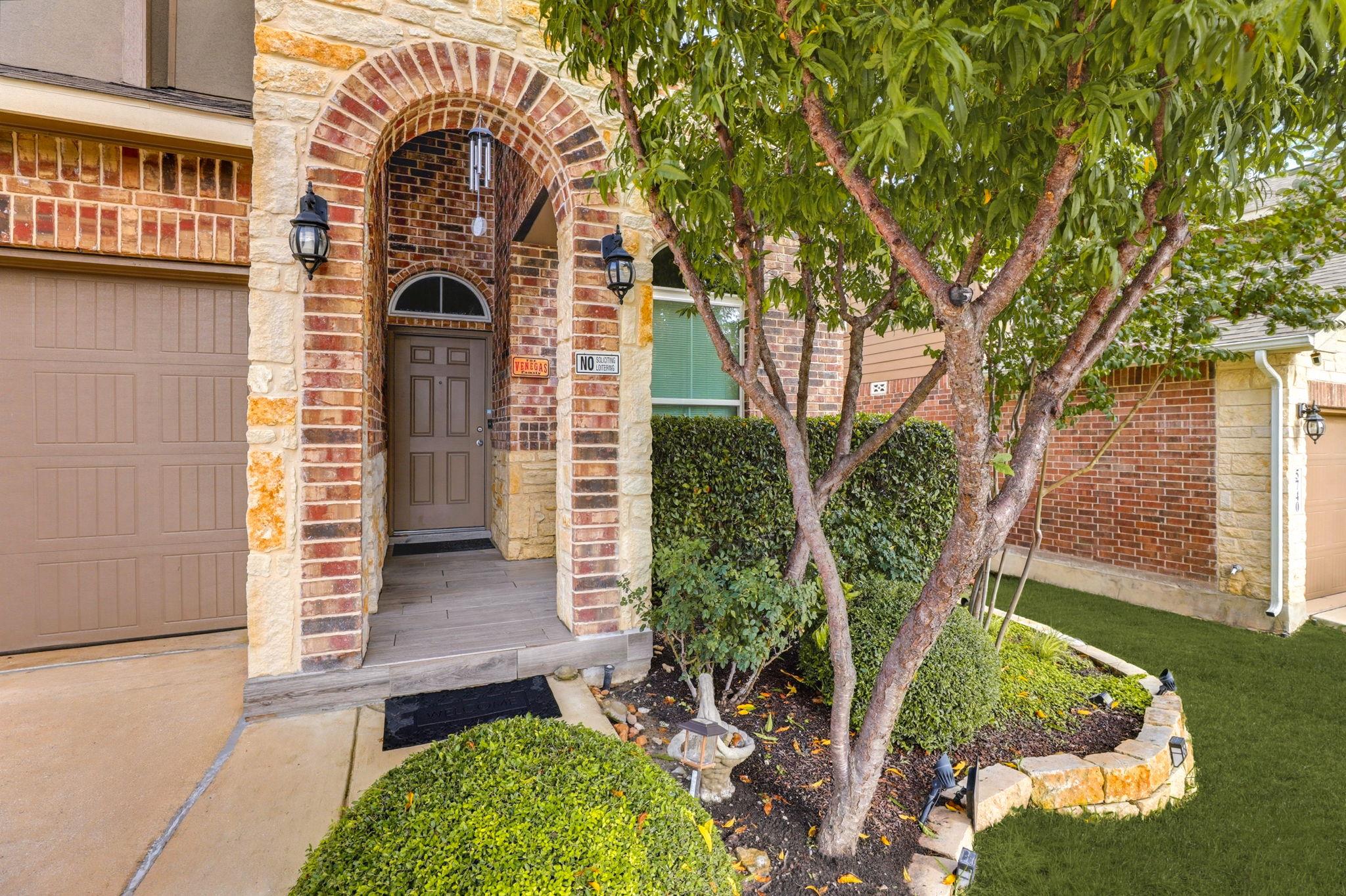 A welcoming front entrance showcases classic bric