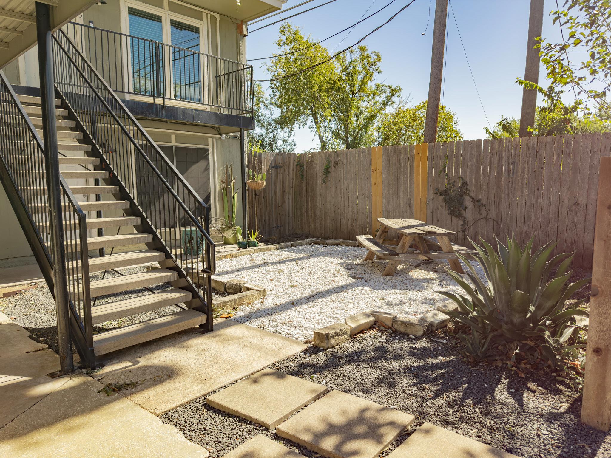 A private outdoor space with a gravel patio and a