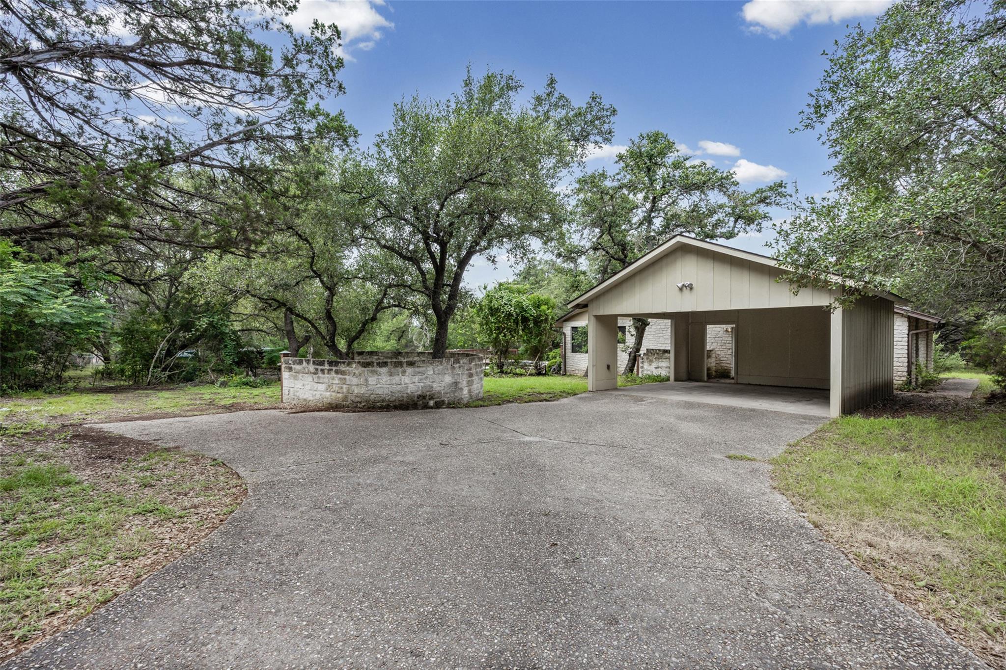 A private driveway leads to a convenient carport,