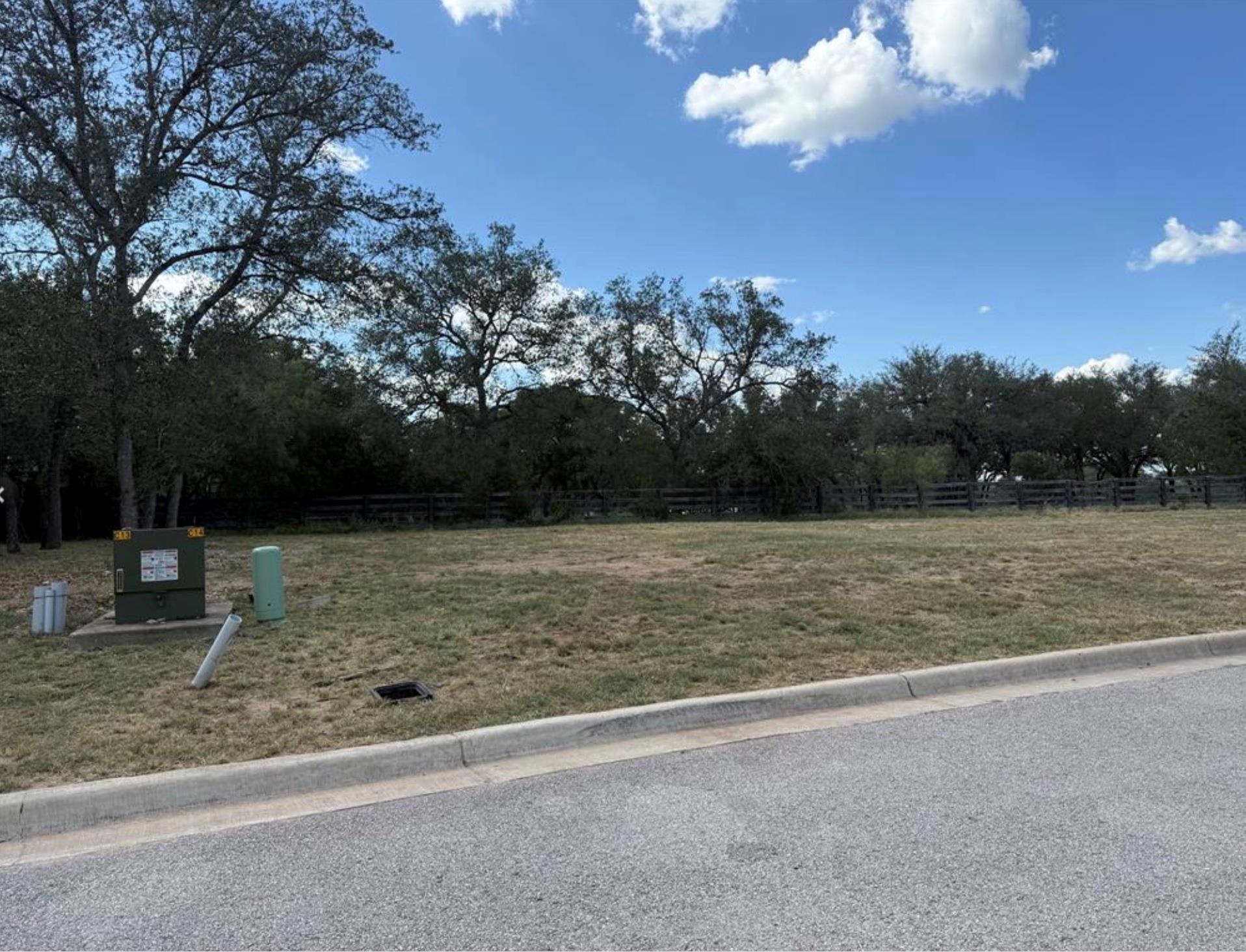 A spacious lot ready for development, framed by m