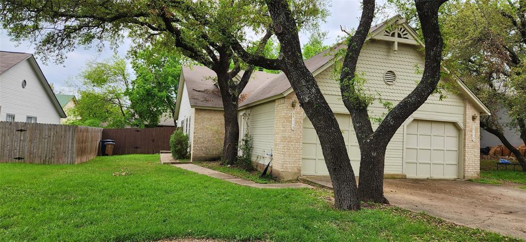 Mature trees shade a private yard, enhancing the 