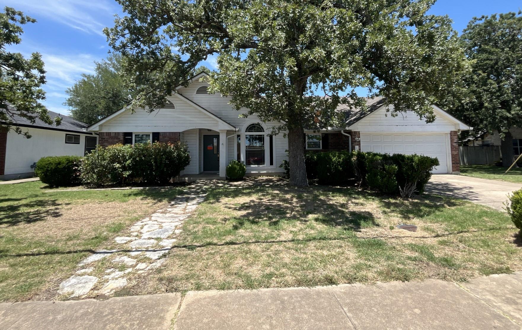 Mature trees shade this inviting single-story res
