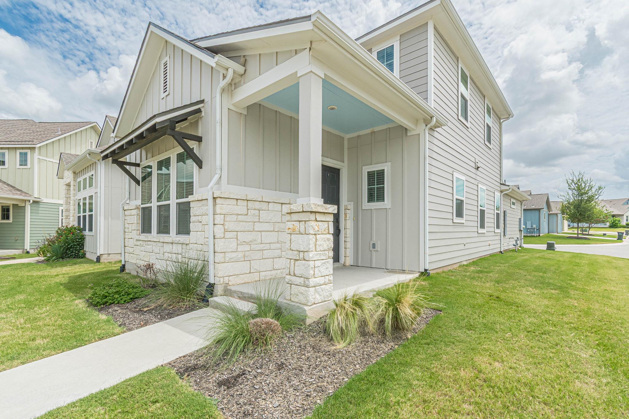 Clean lines and a charming covered porch welcome 