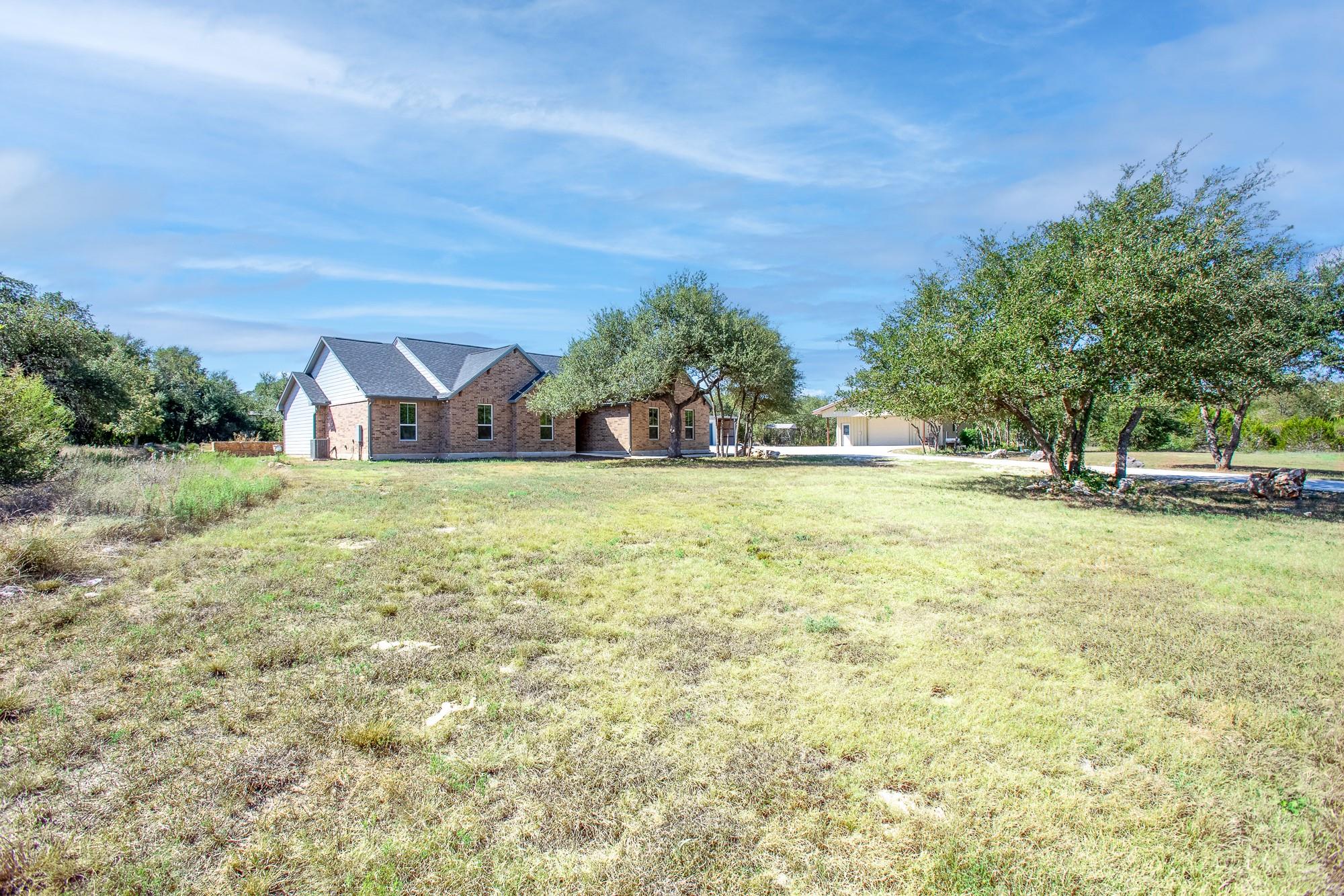 Mature trees shade a classic brick exterior set b