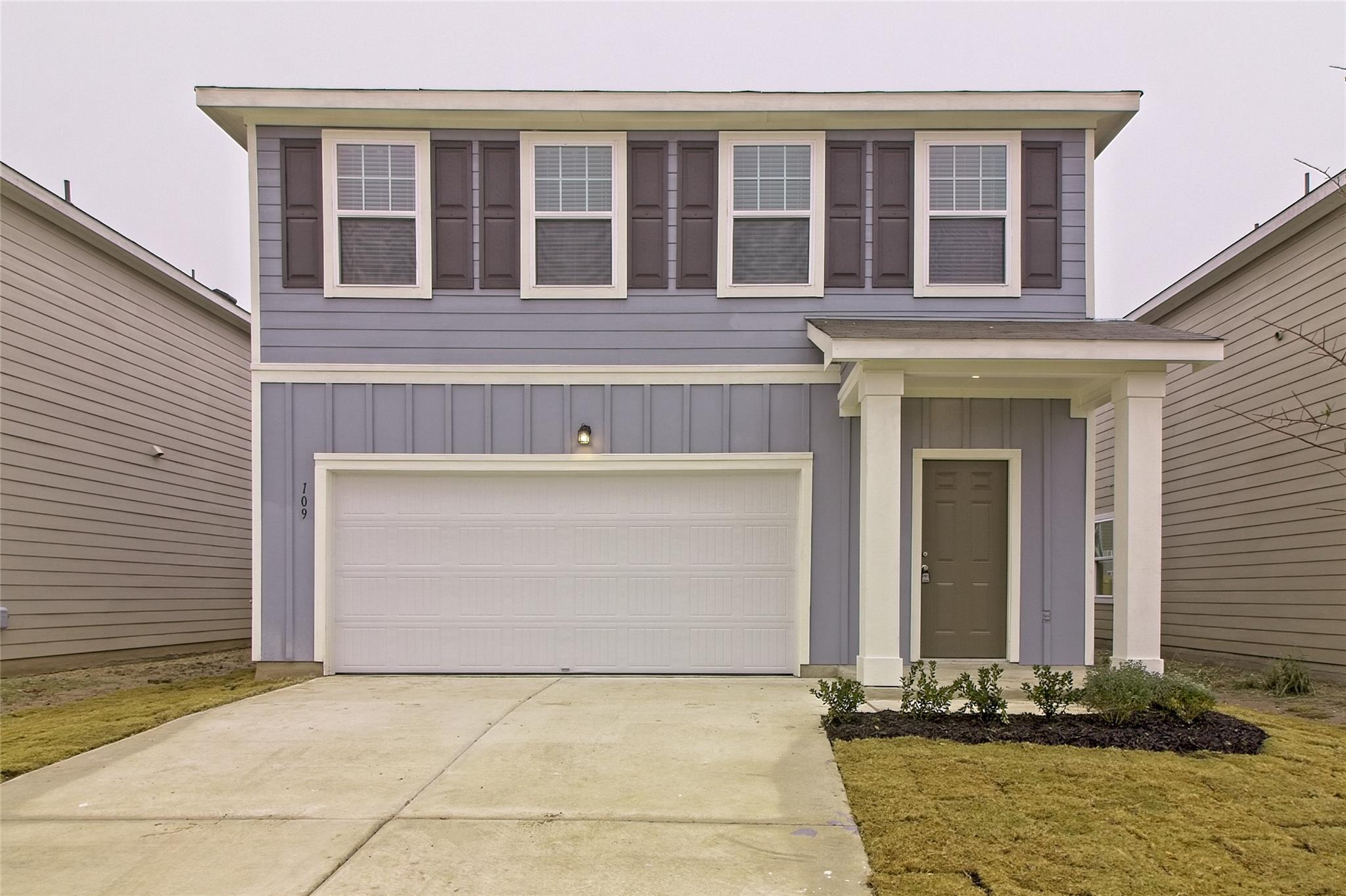 Two-story residence featuring light blue horizont