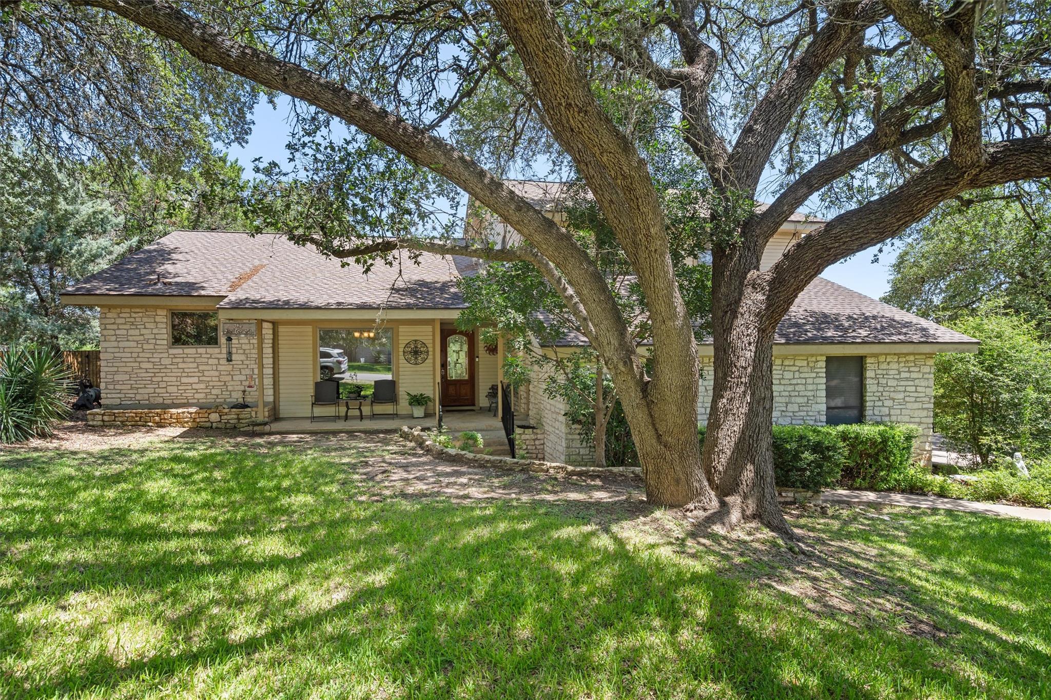 Mature trees shade this inviting single-story res