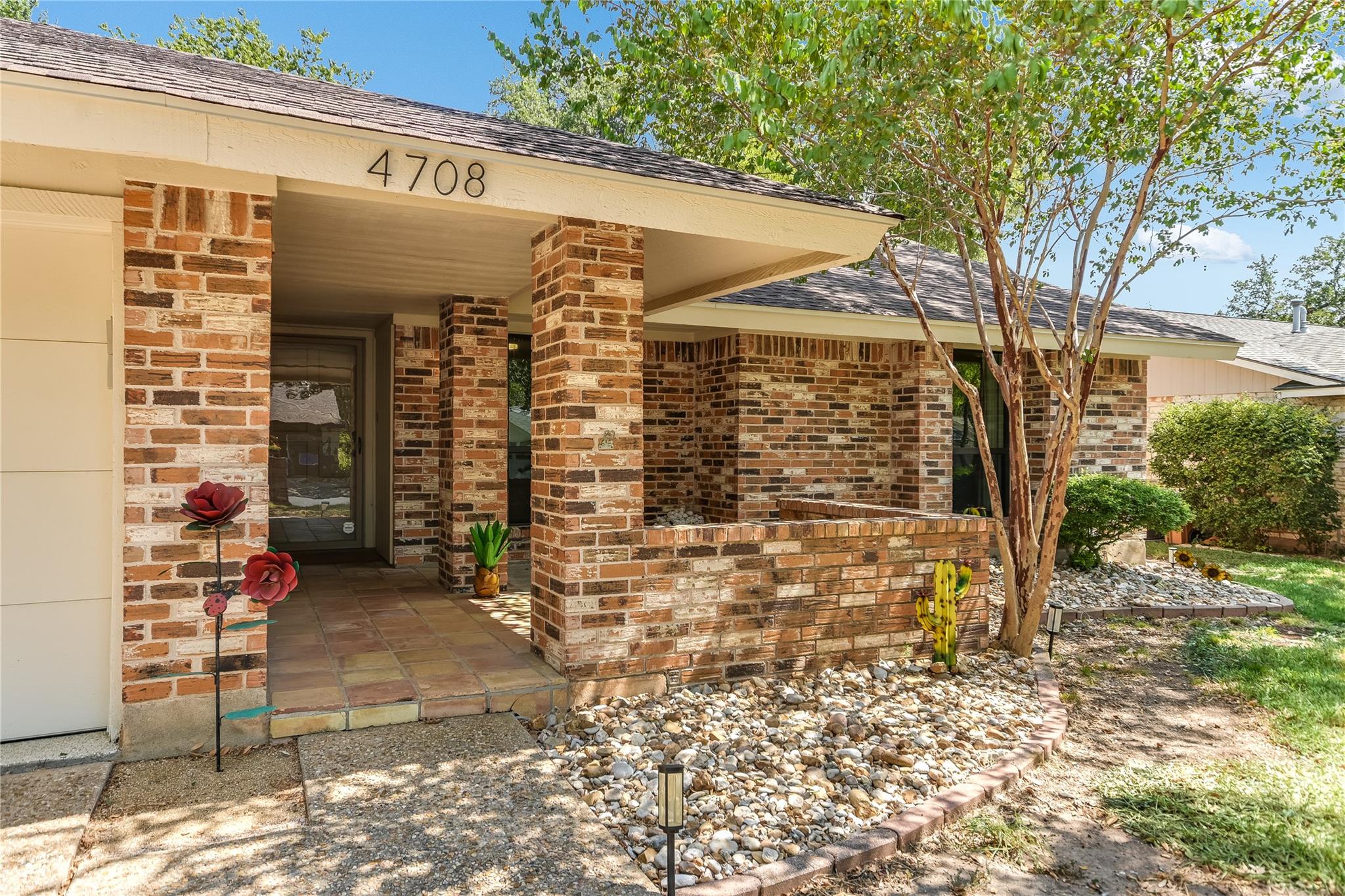 A welcoming front porch with classic brick column