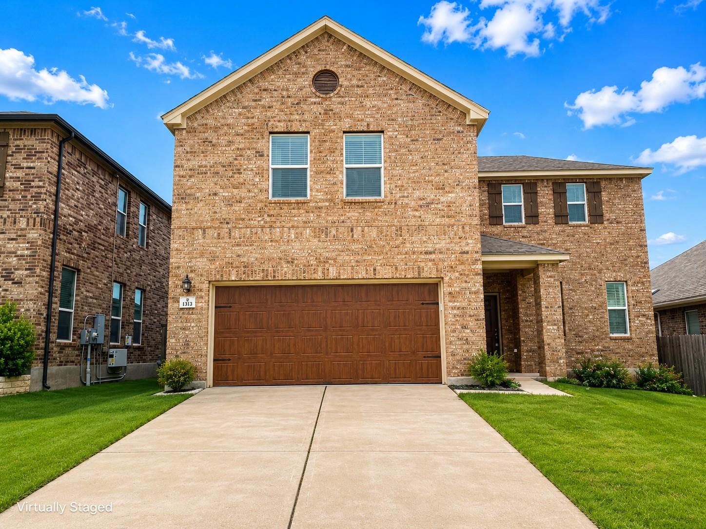 A well-kept brick facade and tidy landscaping cre