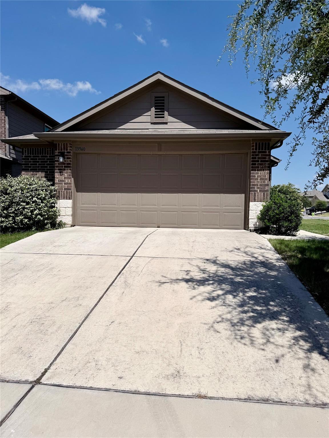 A welcoming front exterior features a two-car gar