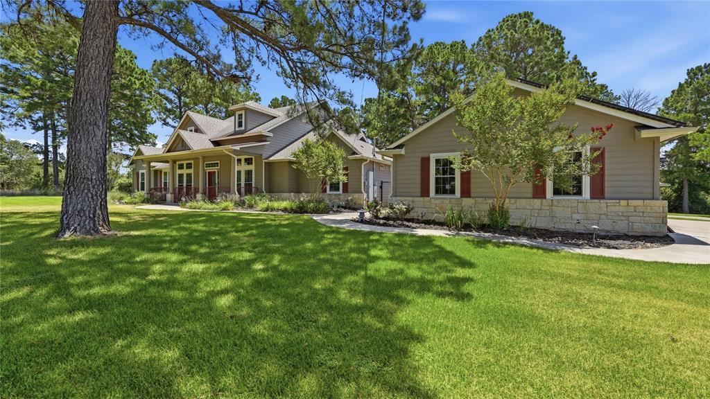 Mature trees and a manicured lawn create a welcom