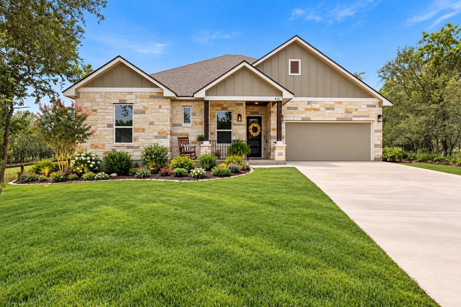 A welcoming front exterior featuring stone accent