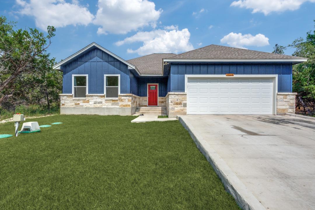 A well-maintained lawn and spacious driveway welc
