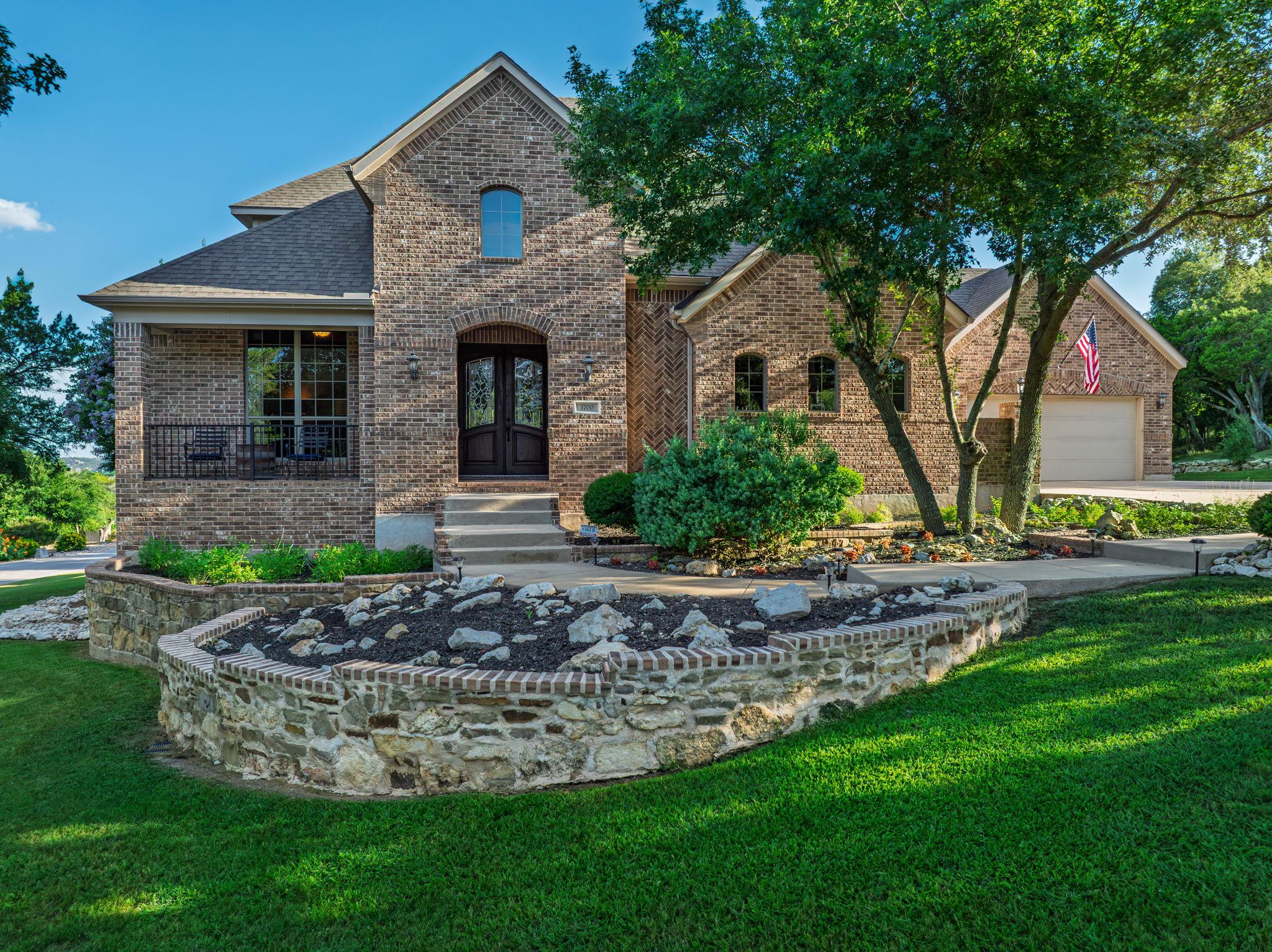 A classic brick exterior with tasteful landscapin