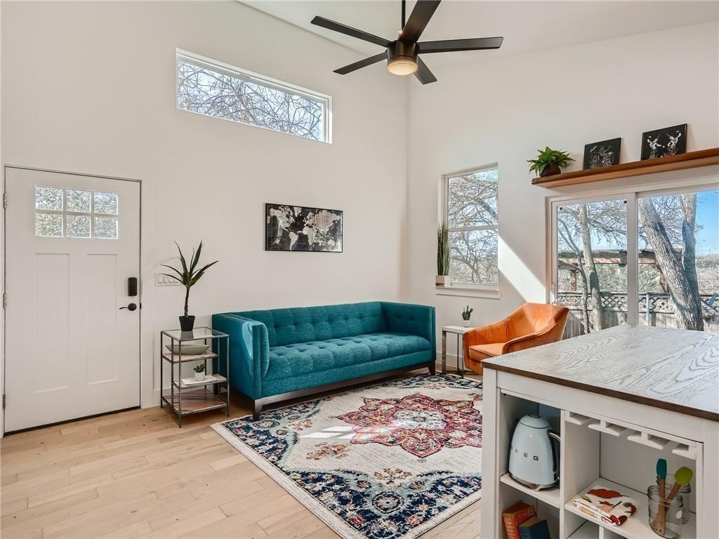 A well-lit living area features soaring ceilings,