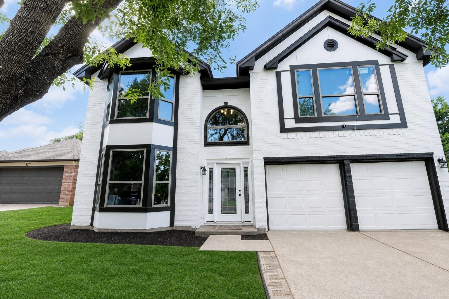 White brick exterior with prominent black trim de