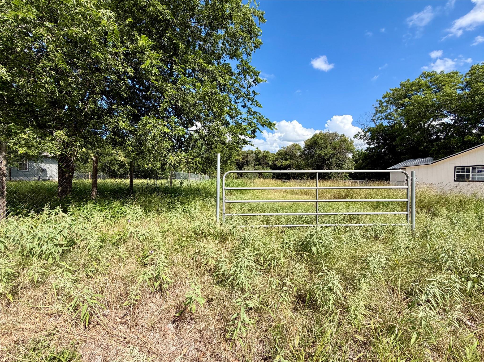 A spacious lot featuring a secure gate, ready for