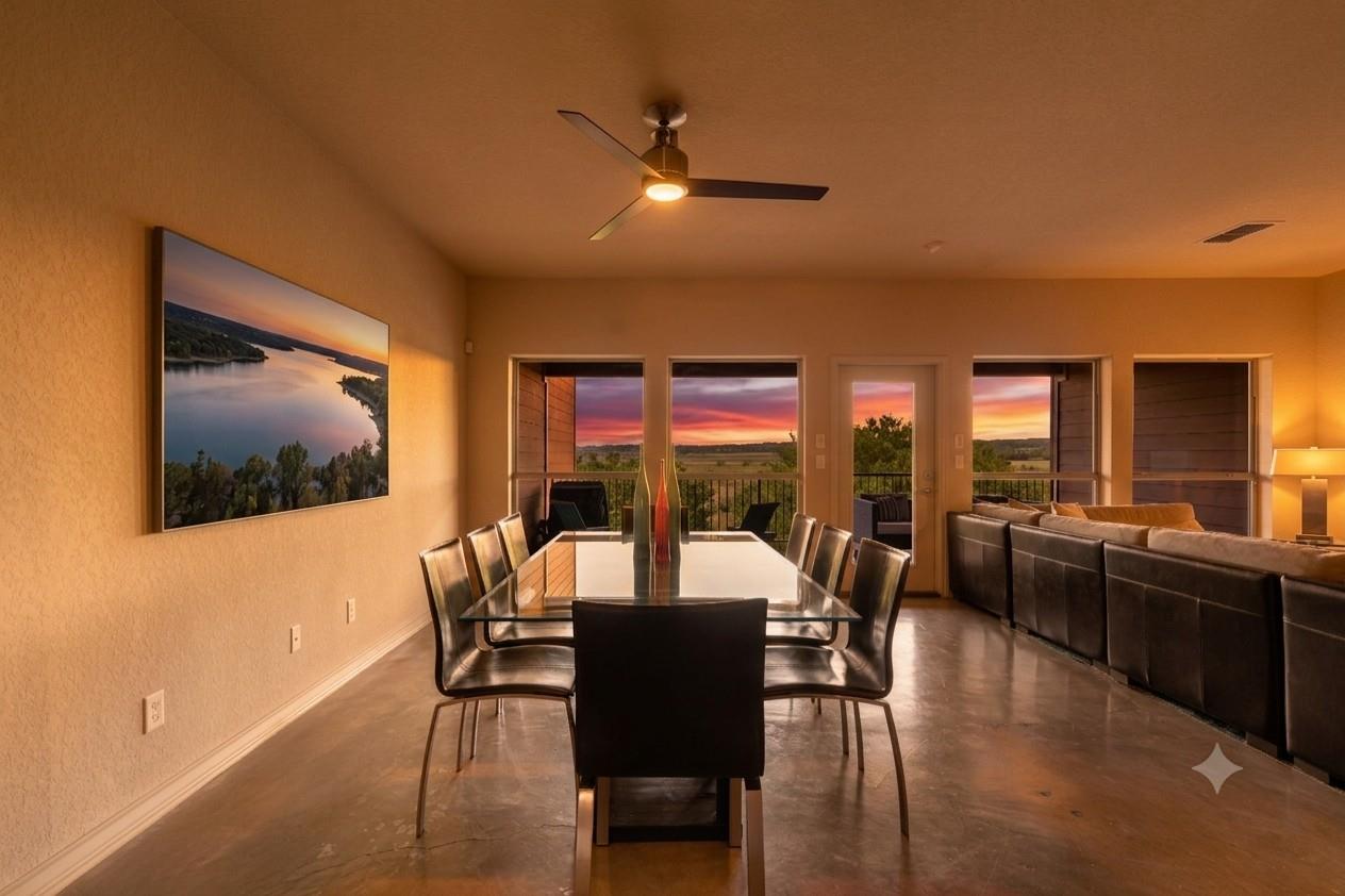 A refined dining room with a glass-top table offe