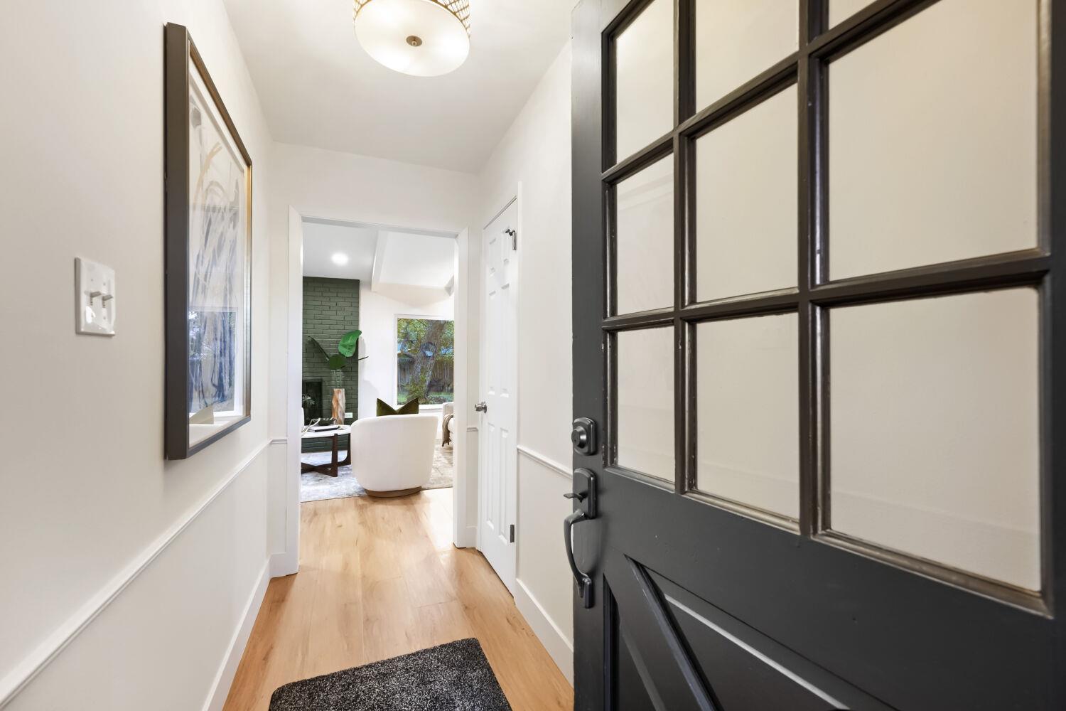 An inviting entrance hallway features warm wood f