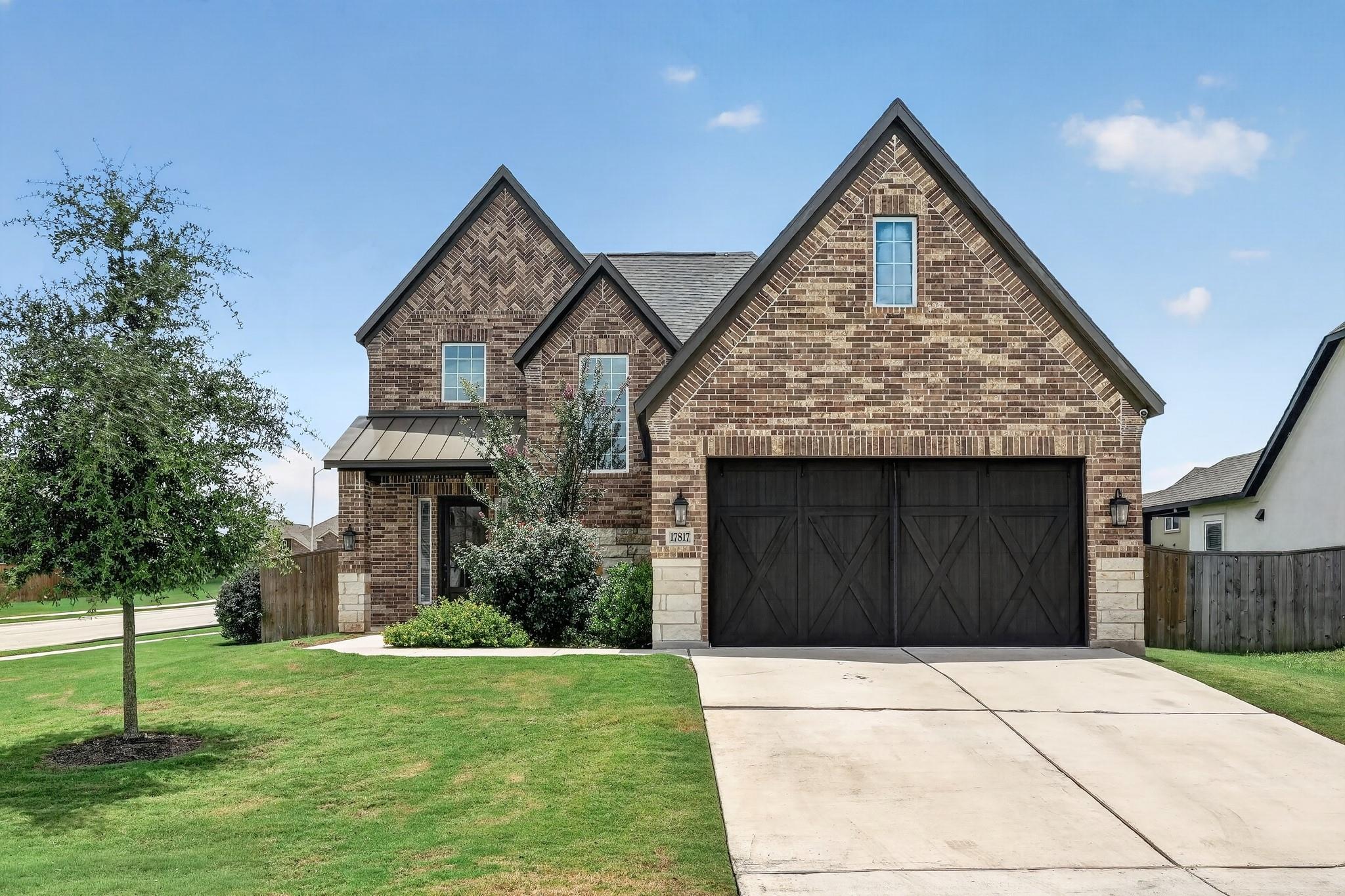 A classic brick exterior with elegant gables welc