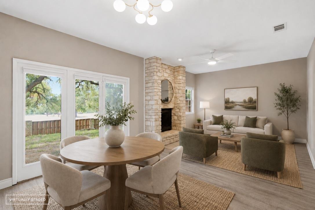 A stone fireplace anchors this living space, feat