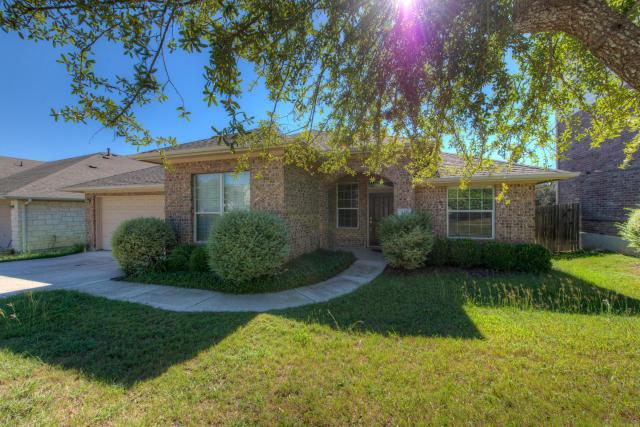 A well-maintained front yard leads to an inviting