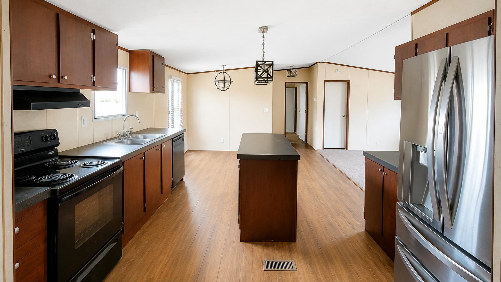 A well-appointed kitchen features dark cabinetry,