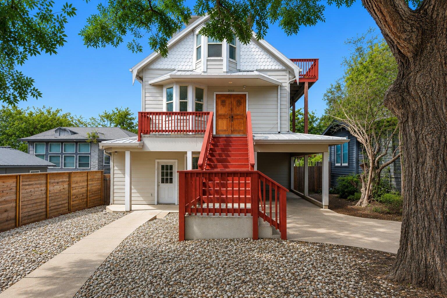Bold red stairs and a matching second-story deck 
